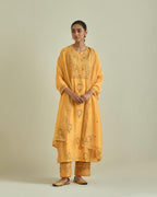 Yellow cotton chanderi straight kurta set with yoke and side panels. It has allover patchwork and silk thread embroidery, highlighted with mirror, sequins, tassels and braids.