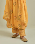 Yellow cotton chanderi straight kurta set with yoke and side panels. It has allover patchwork and silk thread embroidery, highlighted with mirror, sequins, tassels and braids.
