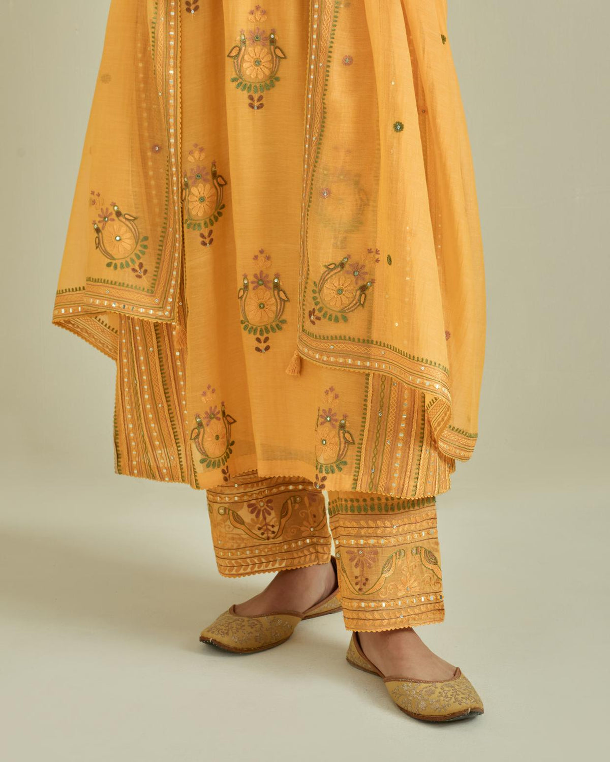 Yellow cotton chanderi straight kurta set with yoke and side panels. It has allover patchwork and silk thread embroidery, highlighted with mirror, sequins, tassels and braids.