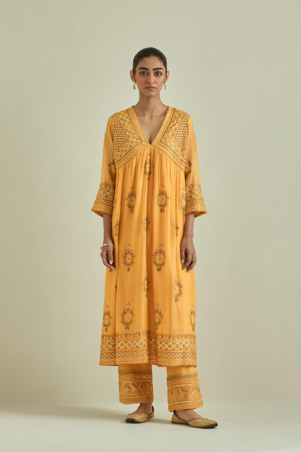 Yellow cotton chanderi embroidered kurta dress set with V neck, yoke and fine gathers at empire line.