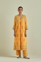 Yellow cotton chanderi embroidered kurta dress set with V neck, yoke and fine gathers at empire line.