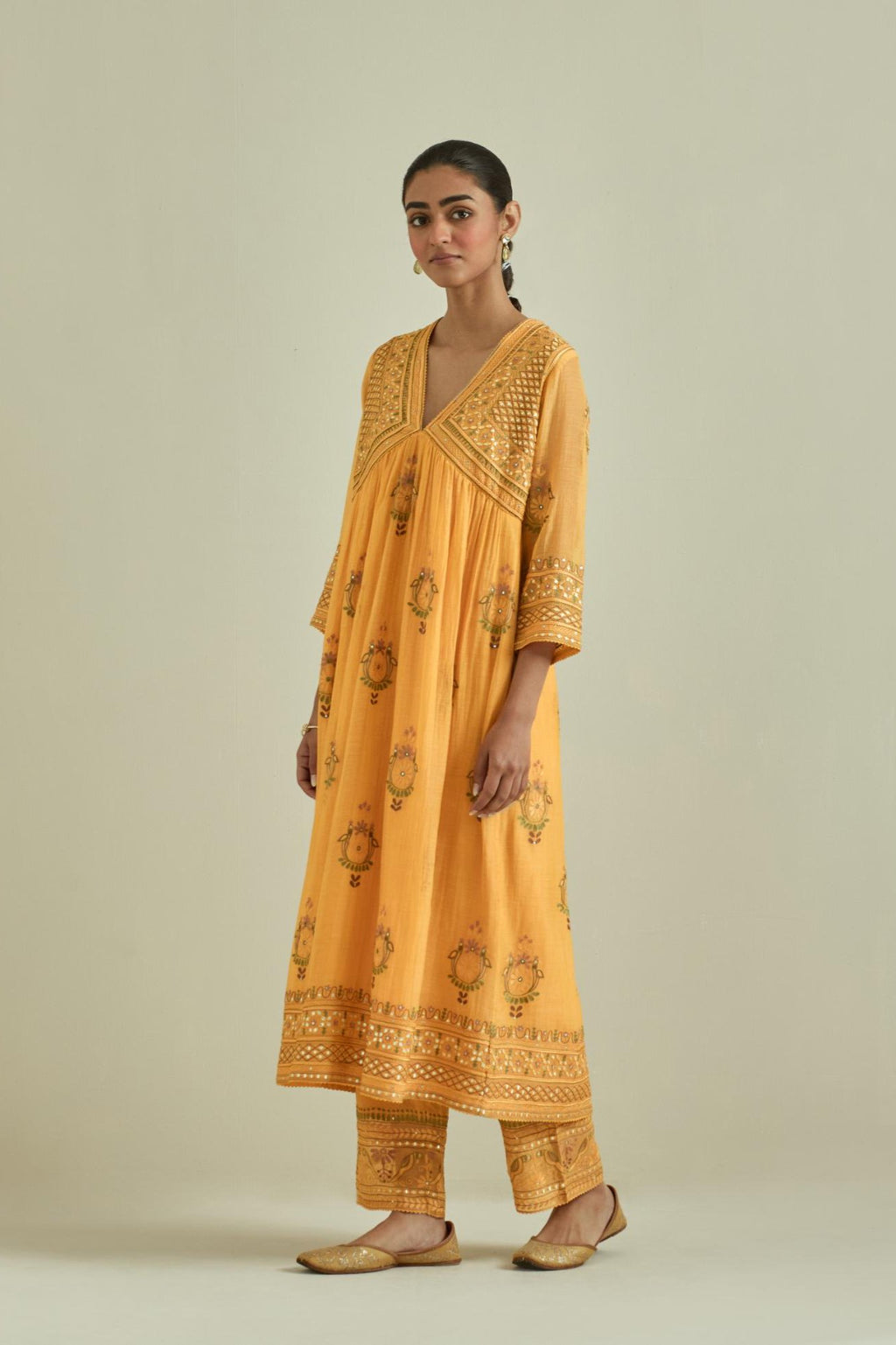 Yellow cotton chanderi embroidered kurta dress set with V neck, yoke and fine gathers at empire line.