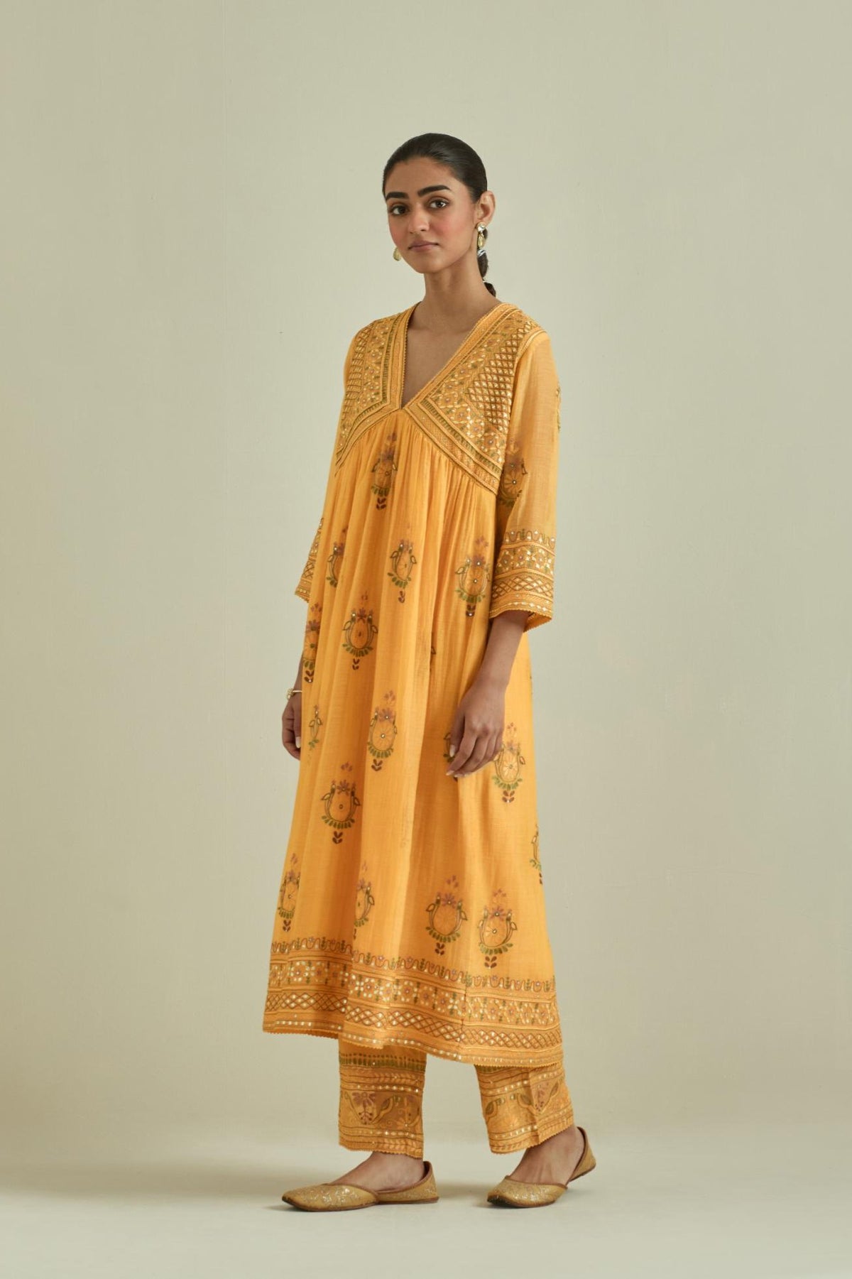 Yellow cotton chanderi embroidered kurta dress set with V neck, yoke and fine gathers at empire line.