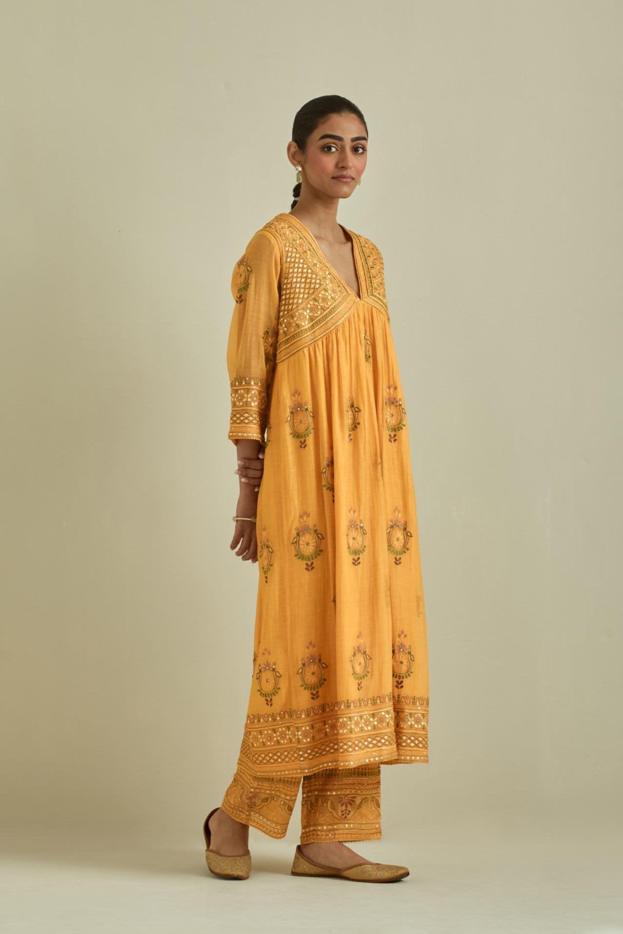 Yellow cotton chanderi embroidered kurta dress set with V neck, yoke and fine gathers at empire line.