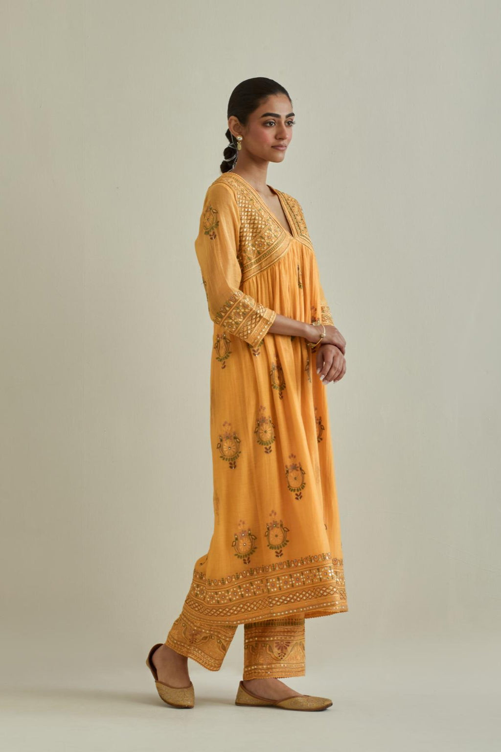 Yellow cotton chanderi embroidered kurta dress set with V neck, yoke and fine gathers at empire line.