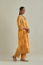 Yellow cotton chanderi embroidered kurta dress set with V neck, yoke and fine gathers at empire line.