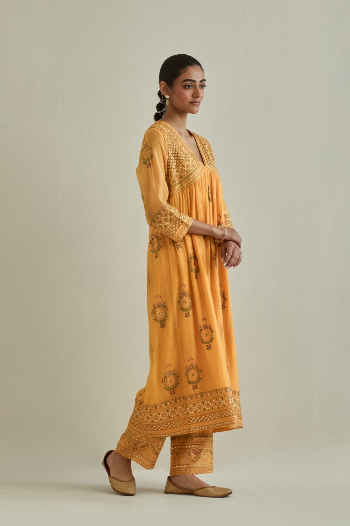 Yellow cotton chanderi embroidered kurta dress set with V neck, yoke and fine gathers at empire line.