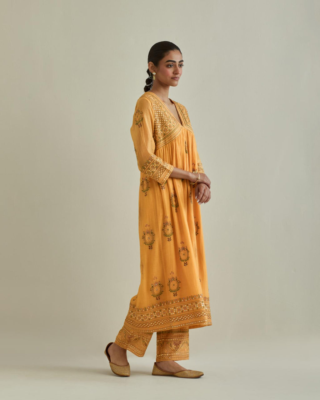 Yellow cotton chanderi embroidered kurta dress set with V neck, yoke and fine gathers at empire line.