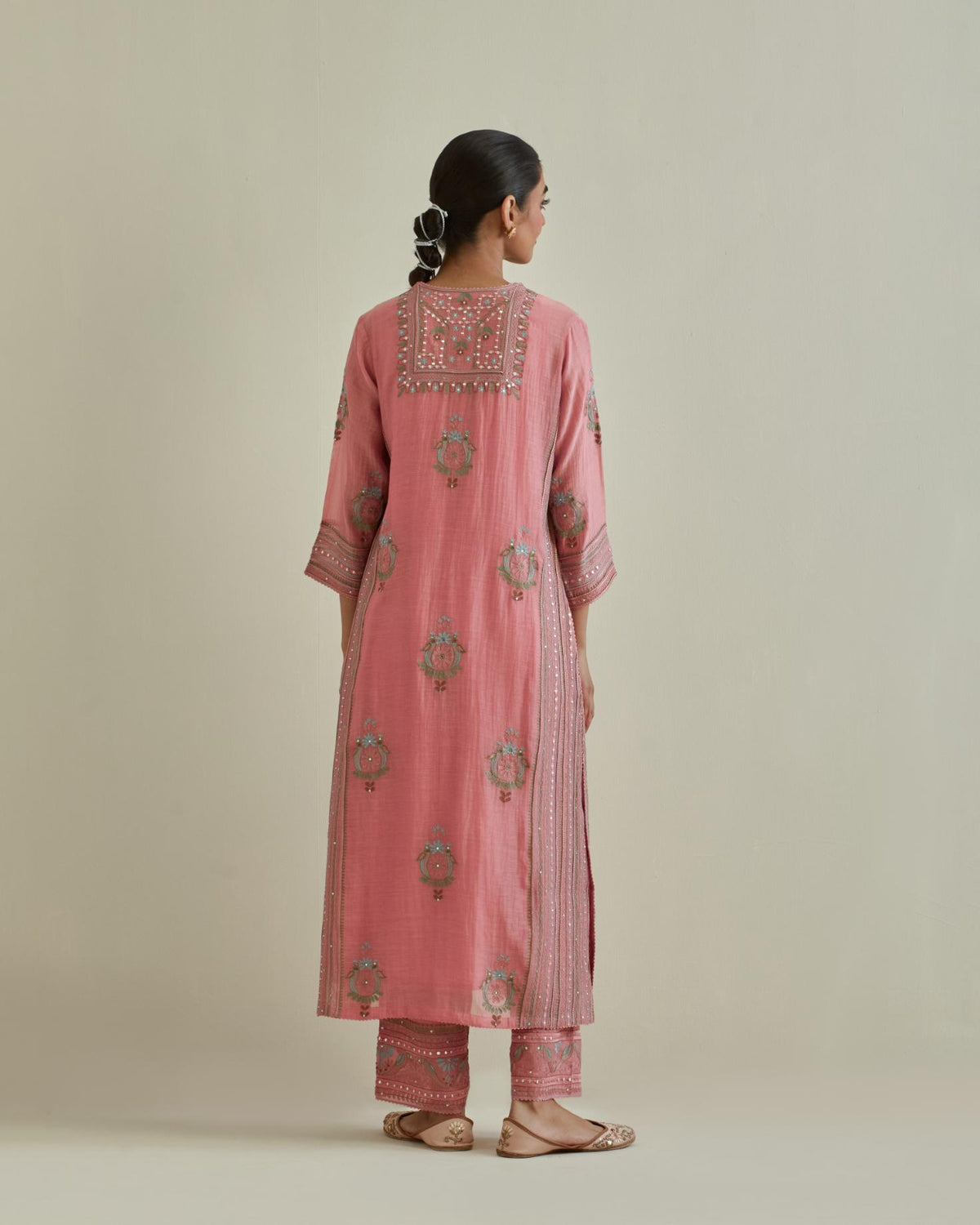 Pink cotton chanderi straight kurta set with yoke and side panels. It has allover patchwork and silk thread embroidery, highlighted with mirror, sequins, tassels and braids.