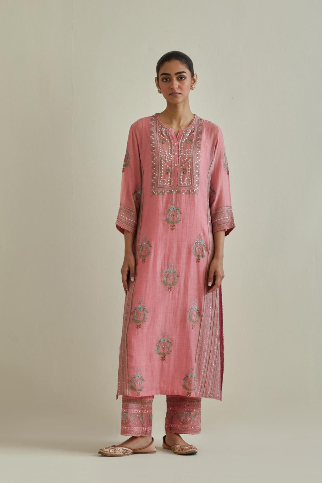 Pink cotton chanderi straight kurta set with yoke and side panels. It has allover patchwork and silk thread embroidery, highlighted with mirror, sequins, tassels and braids.
