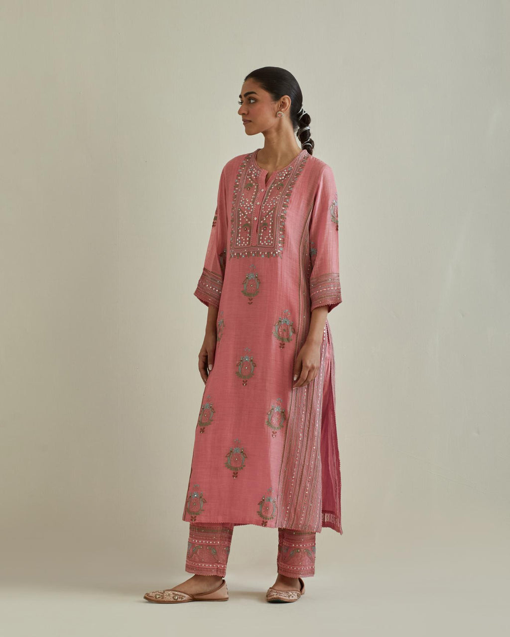 Pink cotton chanderi straight kurta set with yoke and side panels. It has allover patchwork and silk thread embroidery, highlighted with mirror, sequins, tassels and braids.