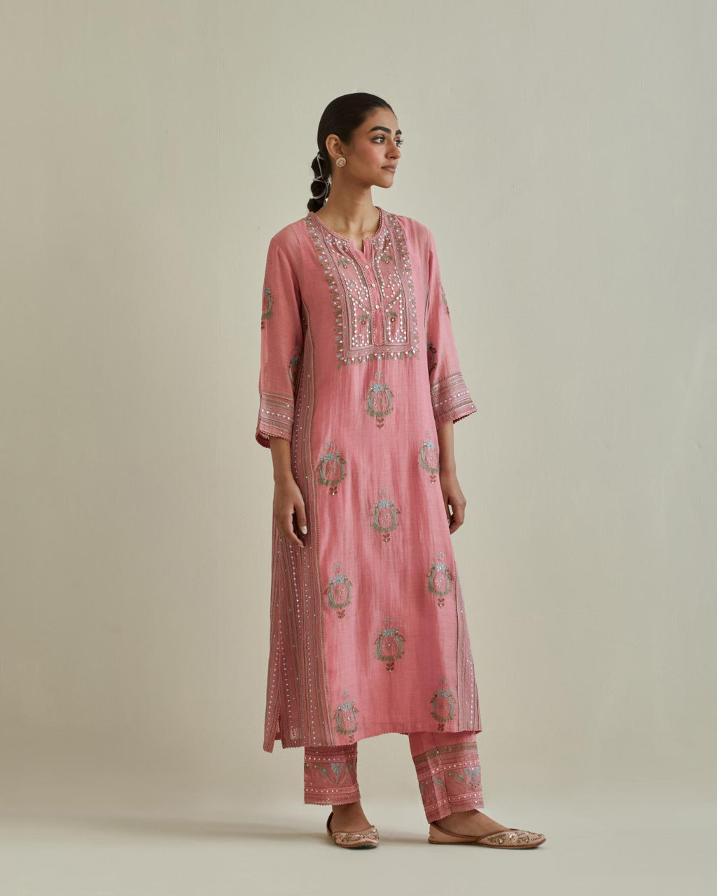 Pink cotton chanderi straight kurta set with yoke and side panels. It has allover patchwork and silk thread embroidery, highlighted with mirror, sequins, tassels and braids.