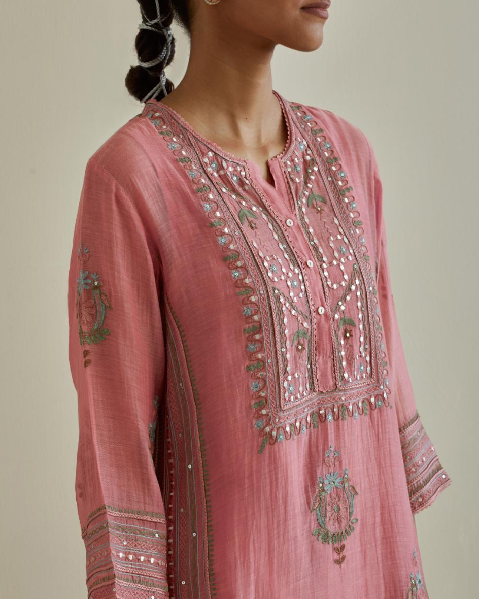 Pink cotton chanderi straight kurta set with yoke and side panels. It has allover patchwork and silk thread embroidery, highlighted with mirror, sequins, tassels and braids.