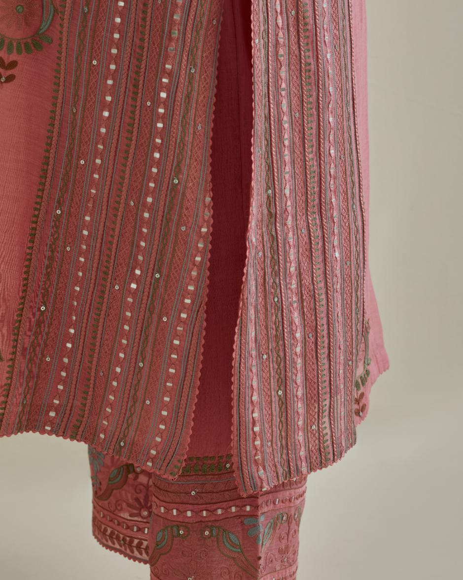 Pink cotton chanderi straight kurta set with yoke and side panels. It has allover patchwork and silk thread embroidery, highlighted with mirror, sequins, tassels and braids.