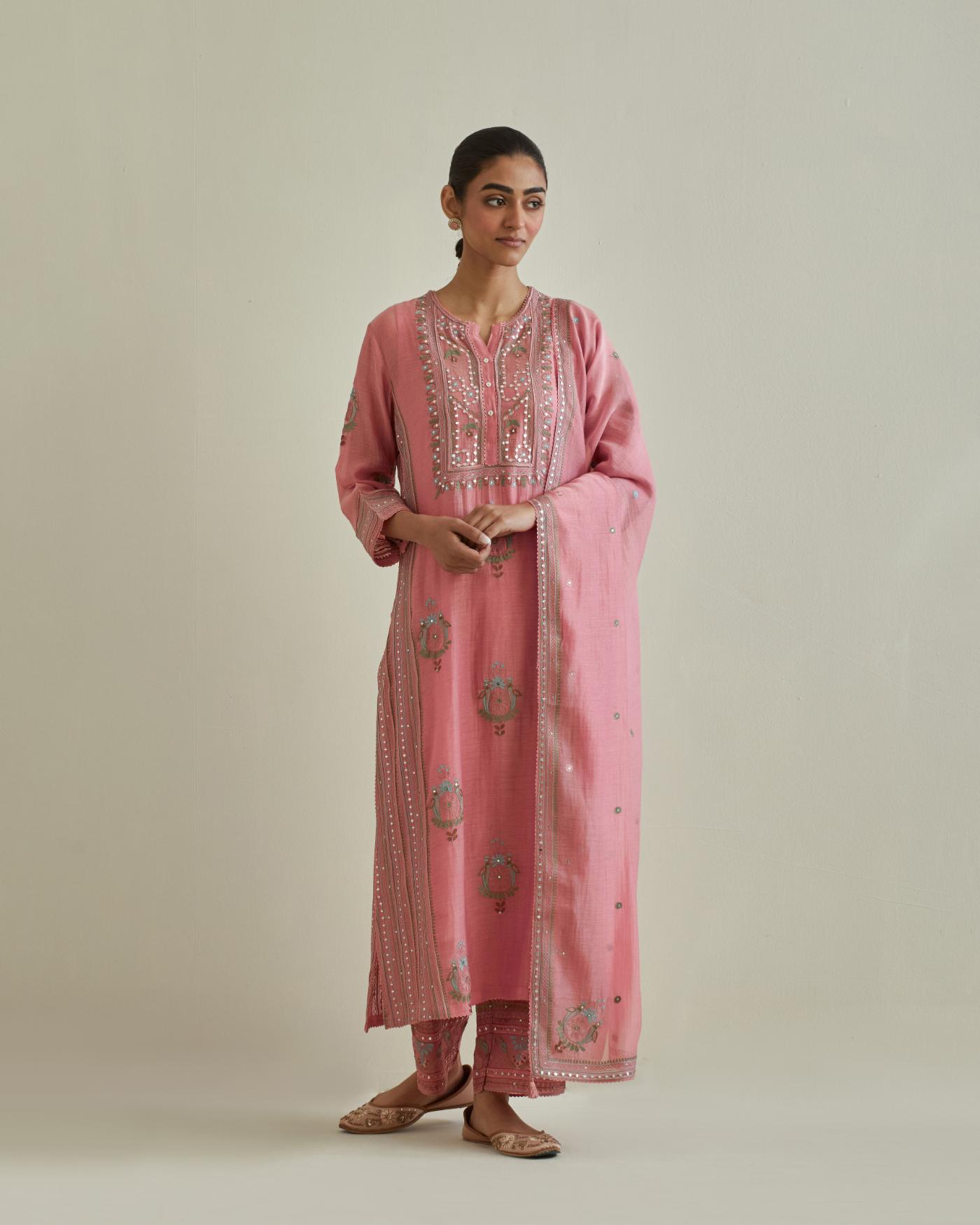 Pink cotton chanderi straight kurta set with yoke and side panels. It has allover patchwork and silk thread embroidery, highlighted with mirror, sequins, tassels and braids.