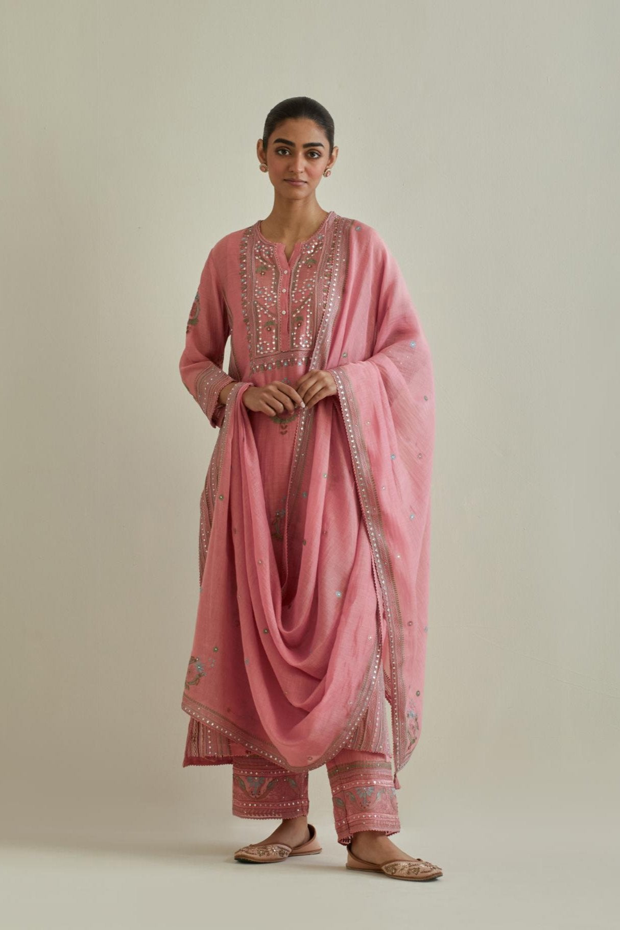 Pink cotton chanderi straight kurta set with yoke and side panels. It has allover patchwork and silk thread embroidery, highlighted with mirror, sequins, tassels and braids.