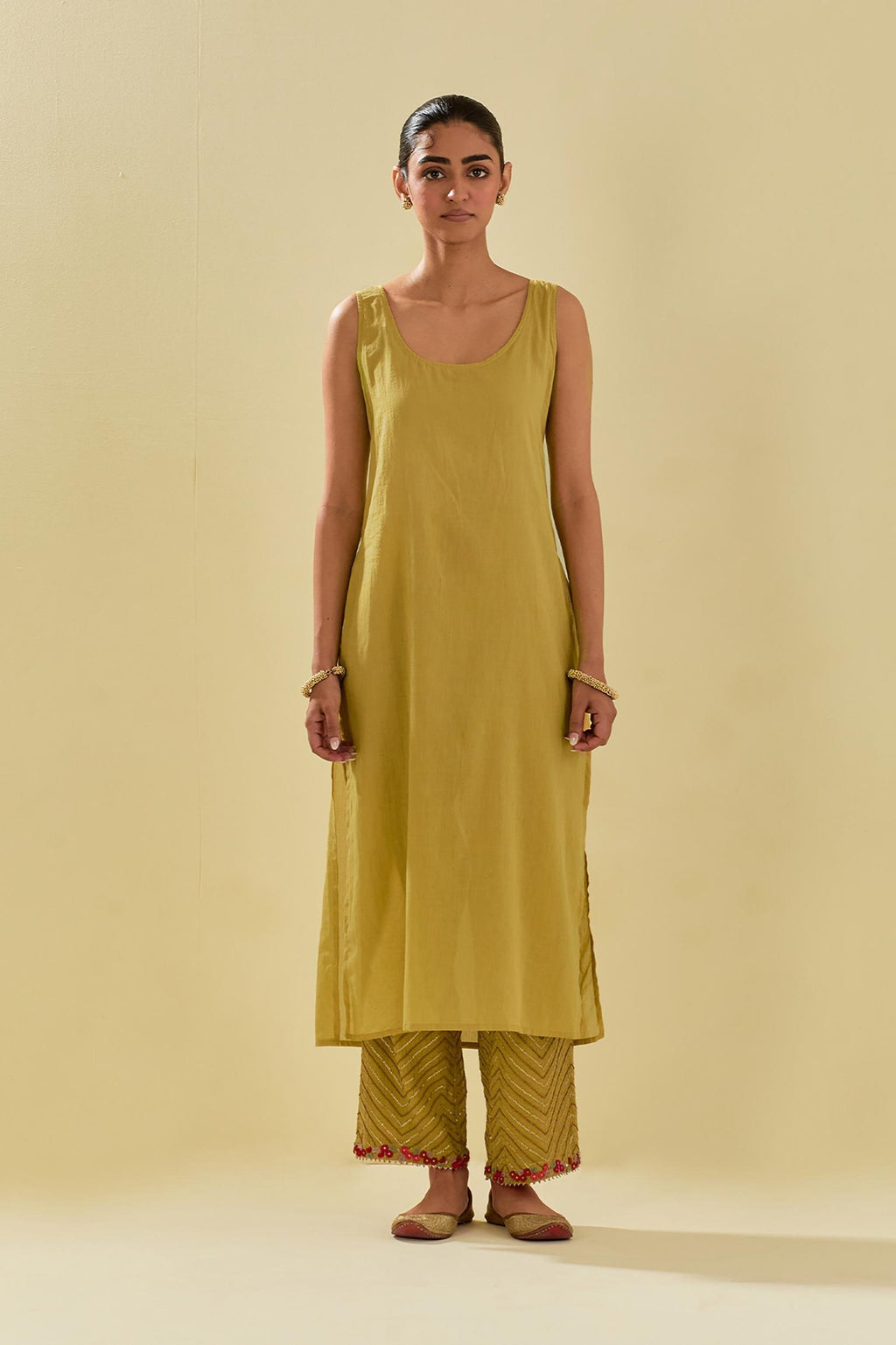 Yellow tissue chanderi straight kurta set with delicate hand cut silk flower embroidery, highlighted with gold sequins and beads.