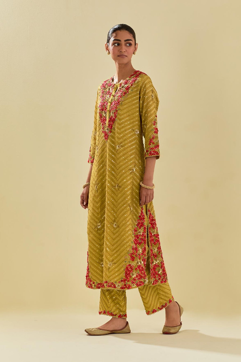 Yellow tissue chanderi straight kurta set with delicate hand cut silk flower embroidery, highlighted with gold sequins and beads.