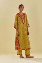 Yellow tissue chanderi straight kurta set with delicate hand cut silk flower embroidery, highlighted with gold sequins and beads.
