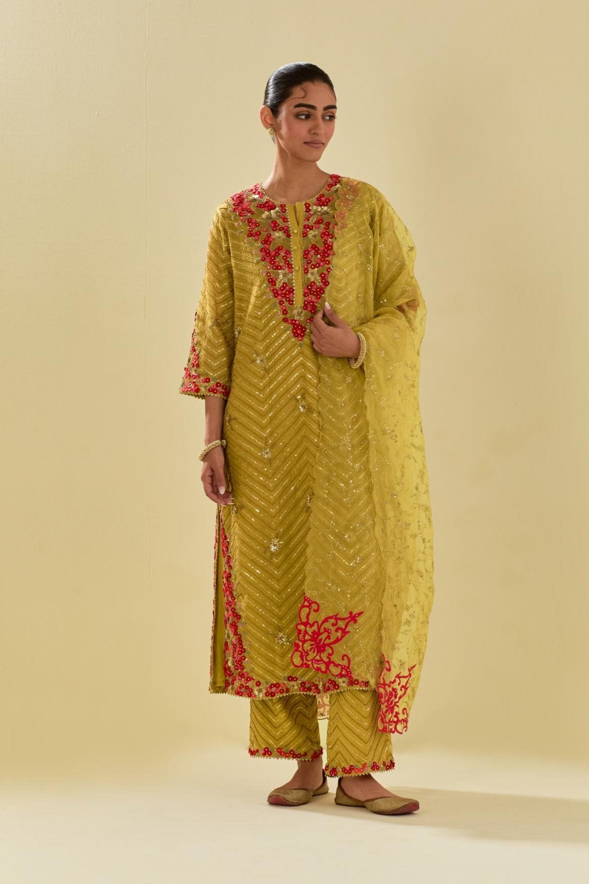 Yellow tissue chanderi straight kurta set with delicate hand cut silk flower embroidery, highlighted with gold sequins and beads.