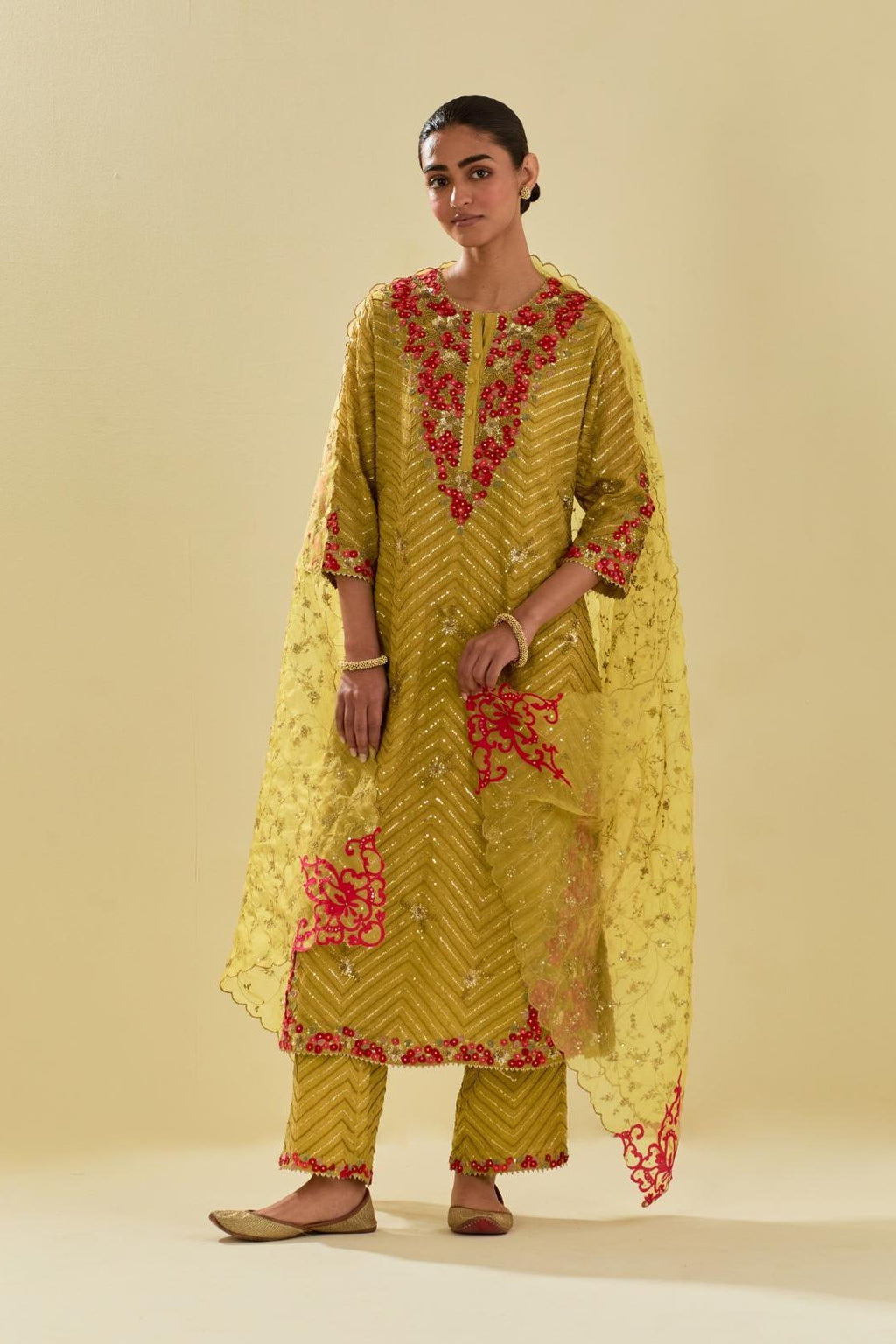 Yellow tissue chanderi straight kurta set with delicate hand cut silk flower embroidery, highlighted with gold sequins and beads.