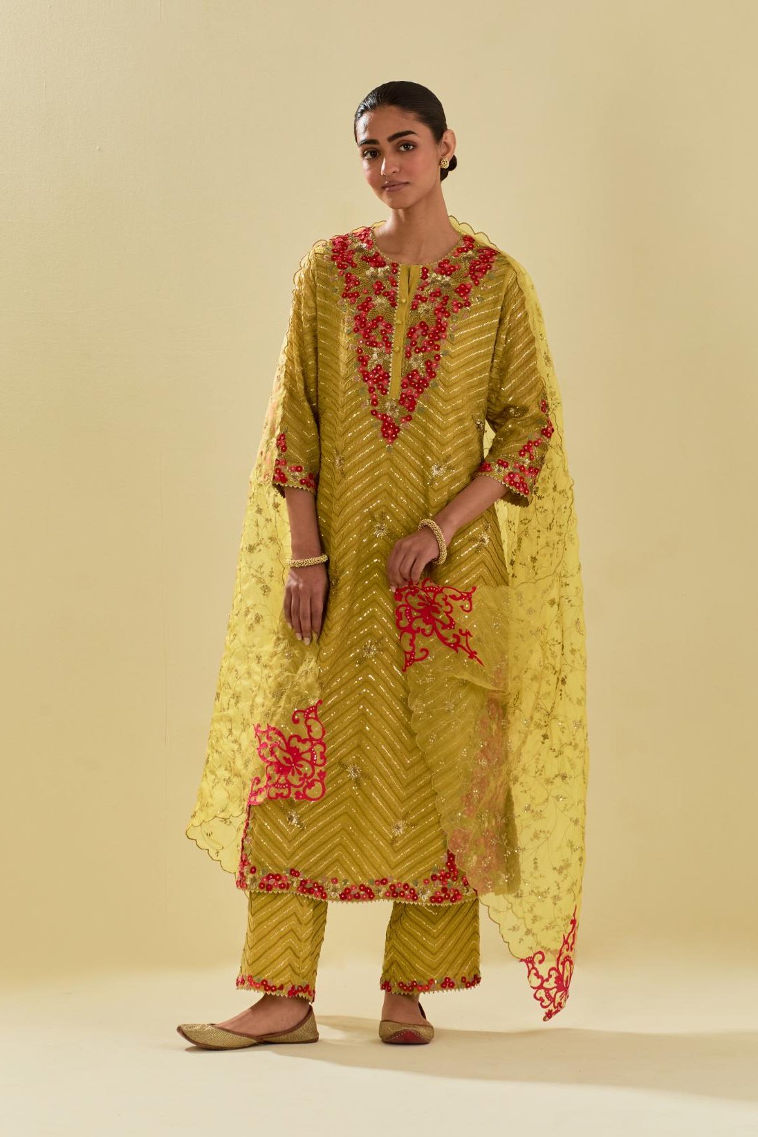 Yellow tissue chanderi straight kurta set with delicate hand cut silk flower embroidery, highlighted with gold sequins and beads.