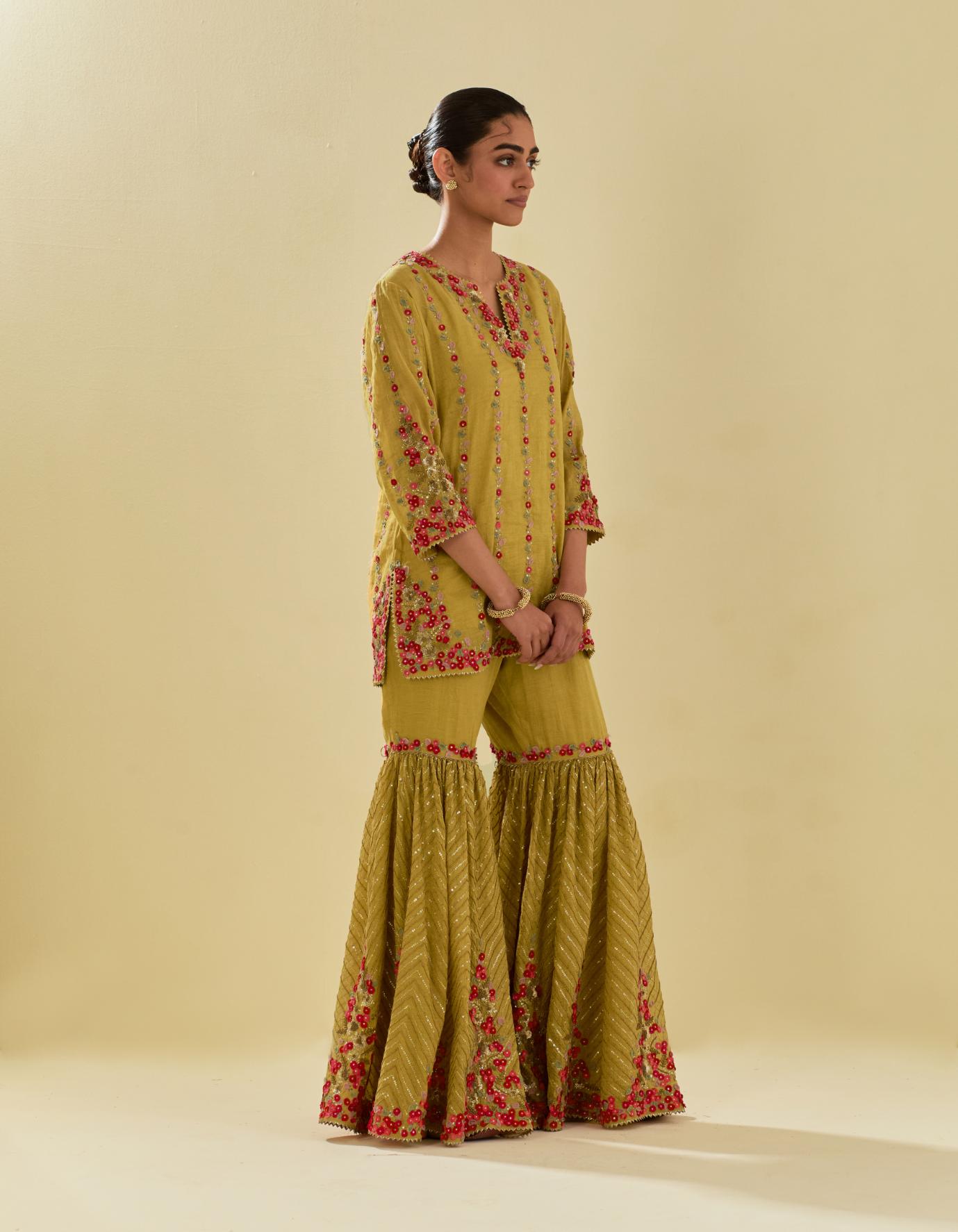 Yellow tissue chanderi short kurta set with round neck and slit in the front and all-over hand cut silk flower embroidery.