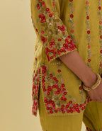 Yellow tissue chanderi short kurta set with round neck and slit in the front and all-over hand cut silk flower embroidery.