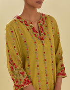 Yellow tissue chanderi short kurta set with round neck and slit in the front and all-over hand cut silk flower embroidery.