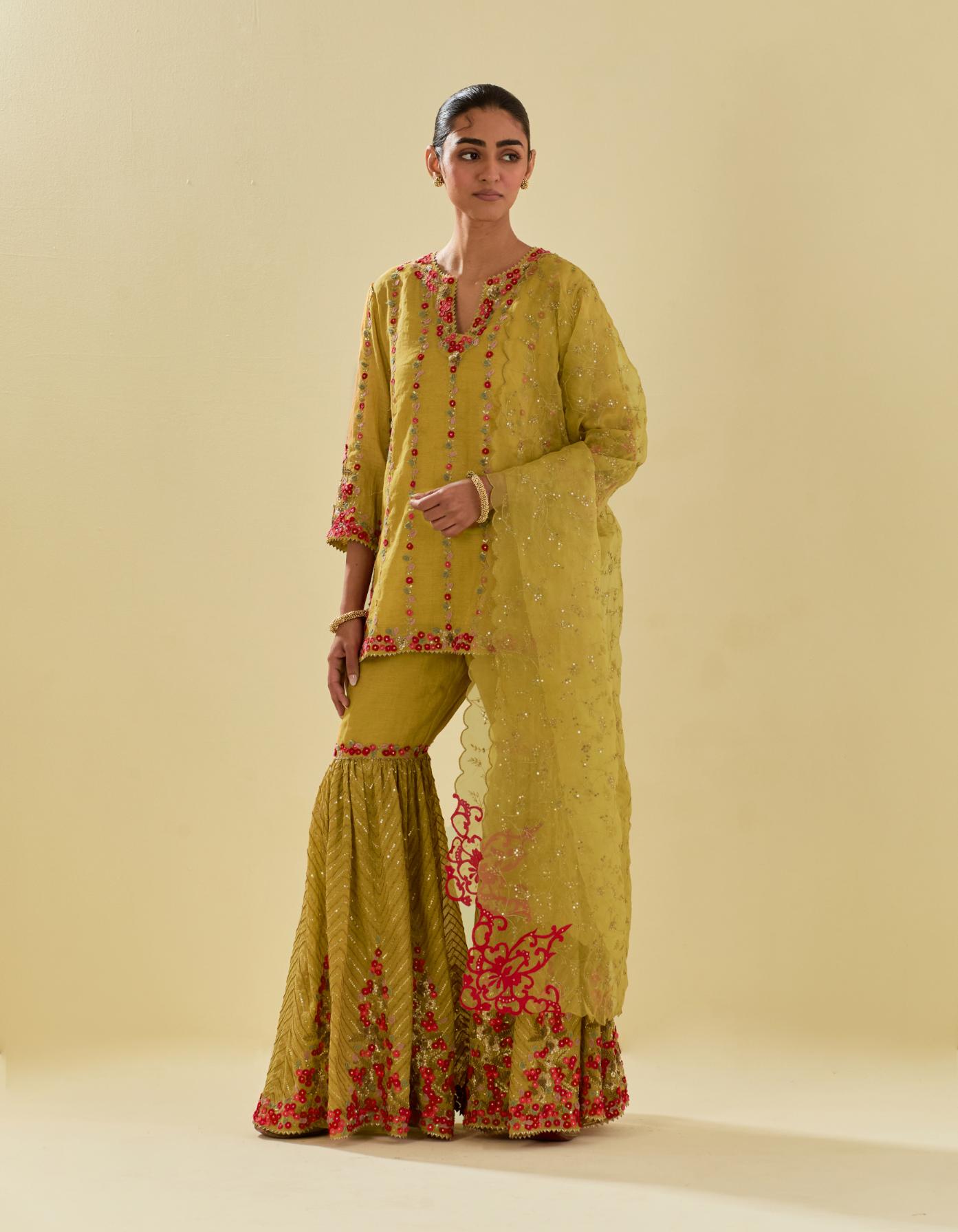 Yellow tissue chanderi short kurta set with round neck and slit in the front and all-over hand cut silk flower embroidery.