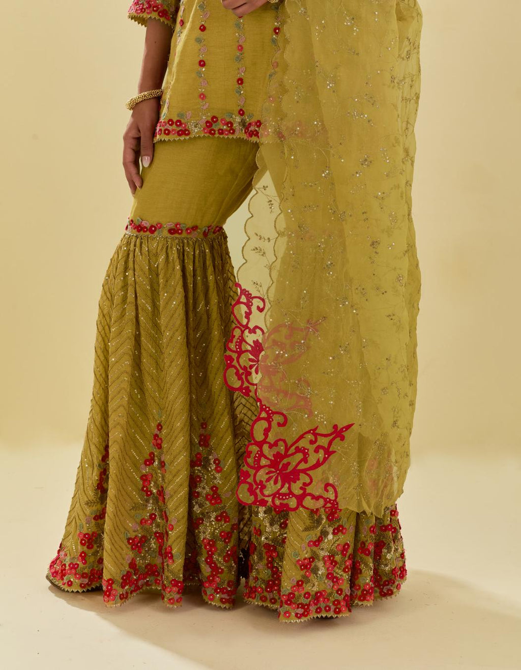 Yellow tissue chanderi short kurta set with round neck and slit in the front and all-over hand cut silk flower embroidery.