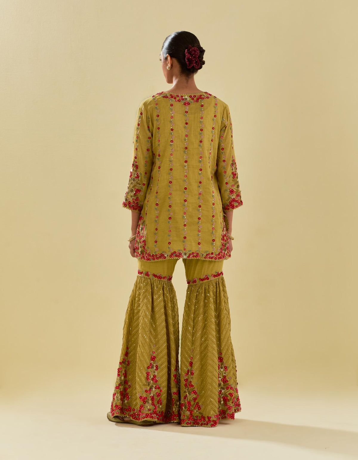 Yellow tissue chanderi short kurta set with round neck and slit in the front and all-over hand cut silk flower embroidery.