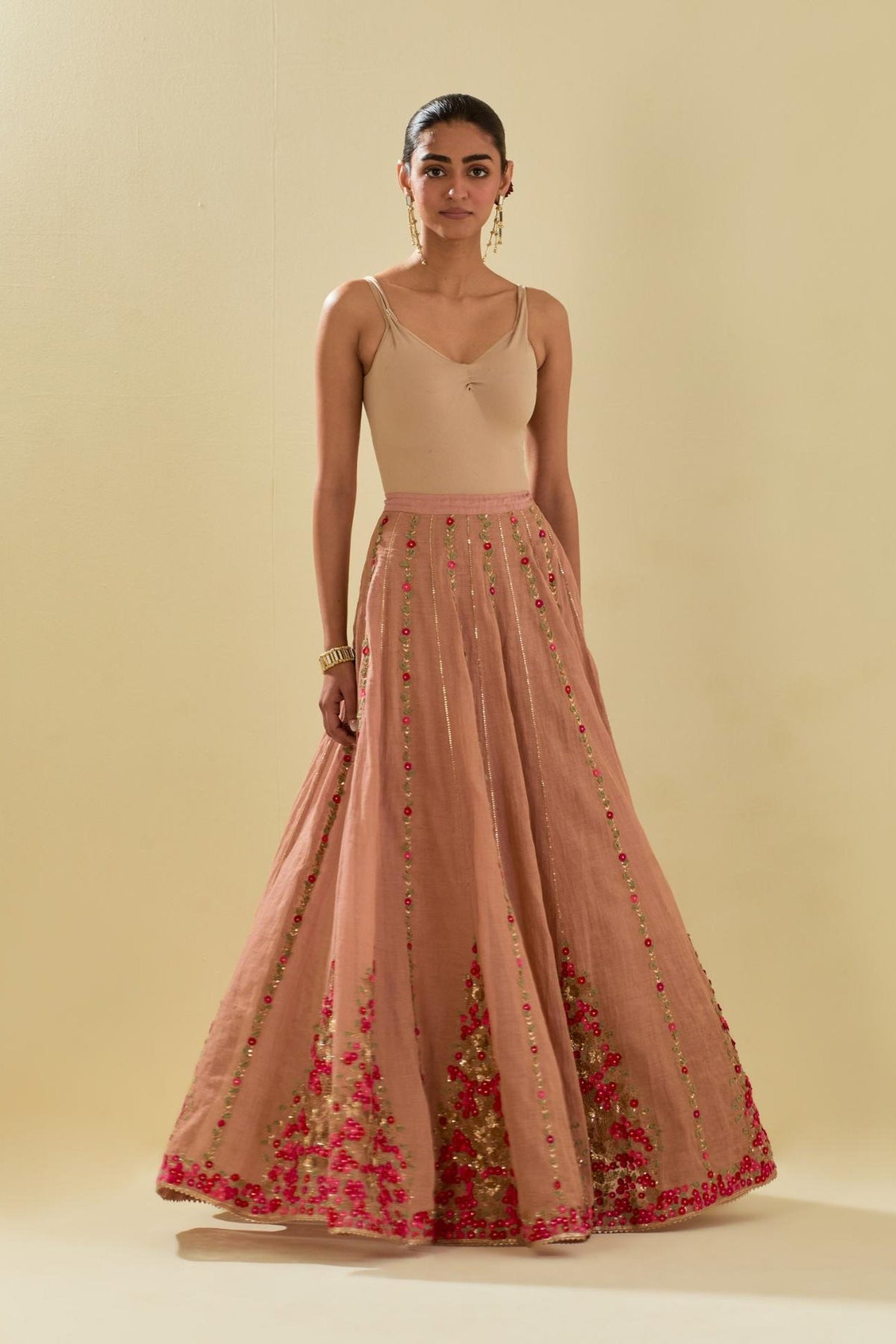 Pink tissue chanderi lehenga with all-over delicate hand cut silk flower embroidery, highlighted with gold sequins.