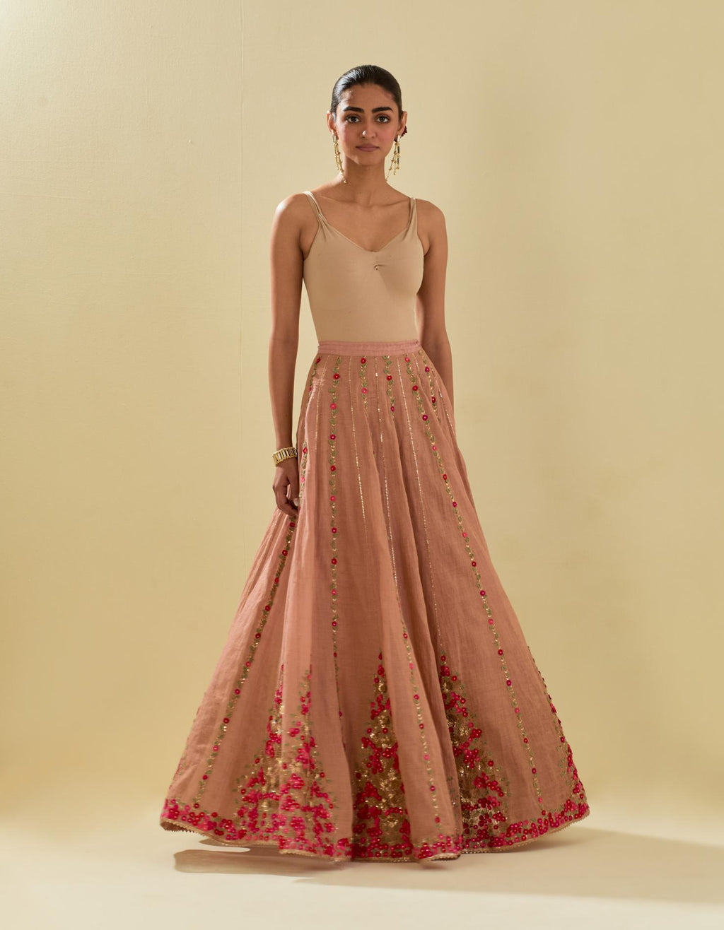 Pink tissue chanderi lehenga with all-over delicate hand cut silk flower embroidery, highlighted with gold sequins.