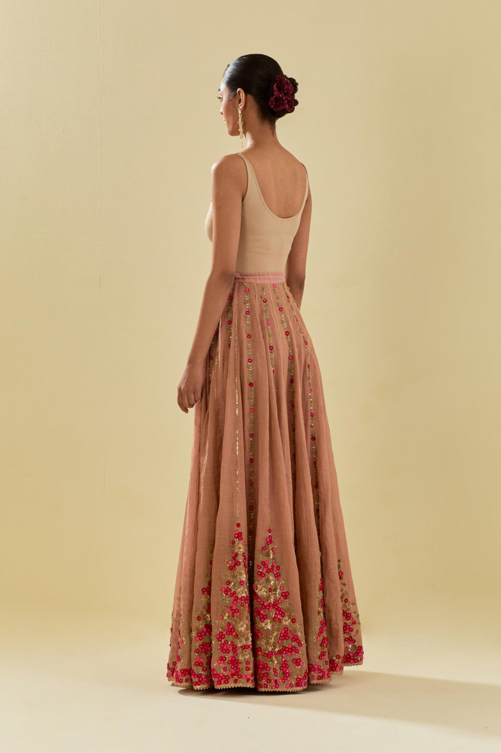 Pink tissue chanderi lehenga with all-over delicate hand cut silk flower embroidery, highlighted with gold sequins.