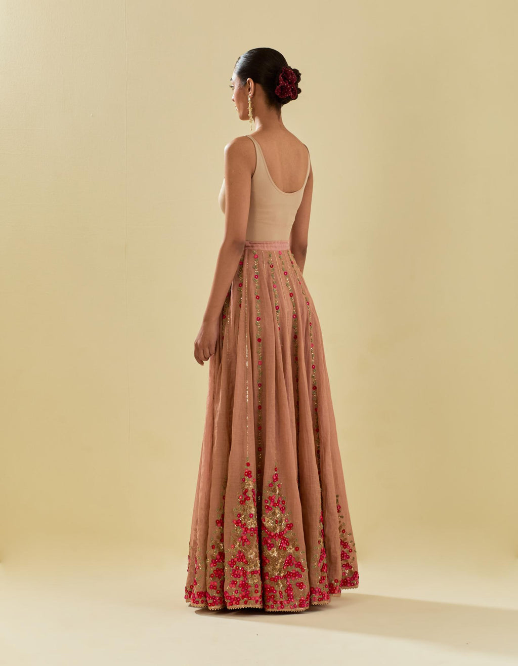 Pink tissue chanderi lehenga with all-over delicate hand cut silk flower embroidery, highlighted with gold sequins.