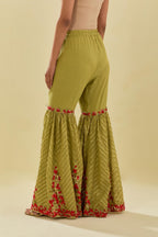 Green tissue chanderi farshi with delicate hand cut silk flower embroidery, highlighted with gold sequins and beads.