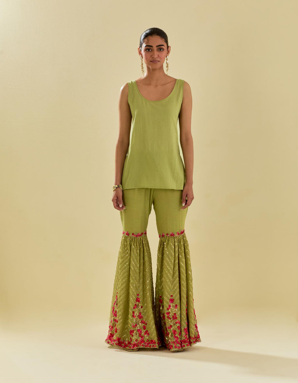Green tissue chanderi short kurta set with round neck and slit in the front and all-over hand cut silk flower embroidery.