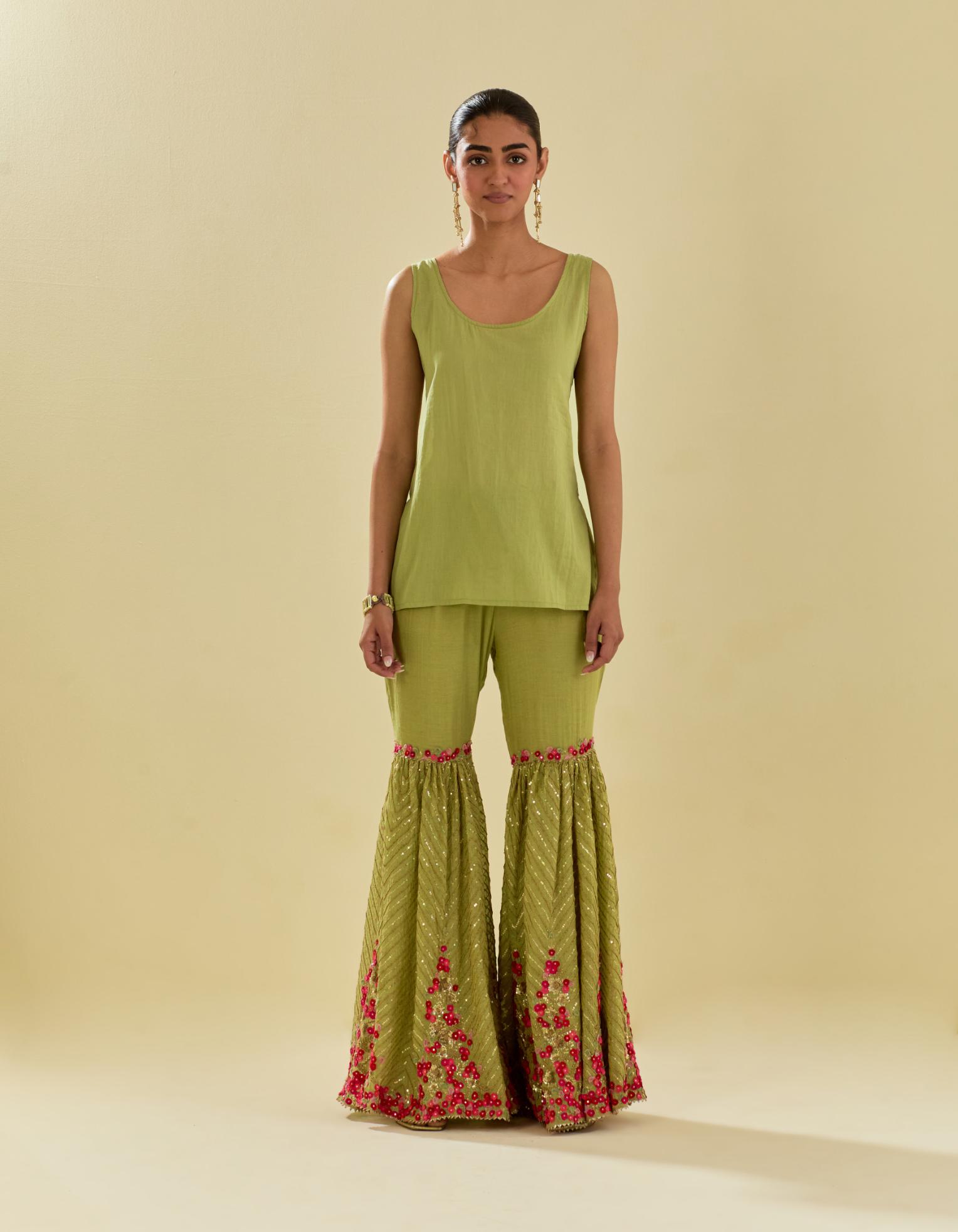 Green tissue chanderi short kurta set with round neck and slit in the front and all-over hand cut silk flower embroidery.