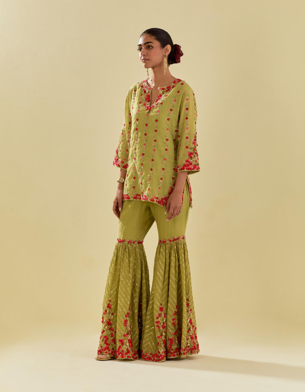 Green tissue chanderi short kurta set with round neck and slit in the front and all-over hand cut silk flower embroidery.