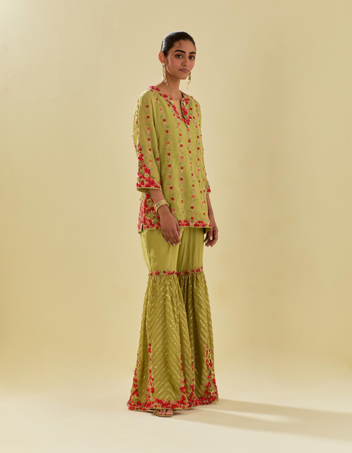 Green tissue chanderi short kurta set with round neck and slit in the front and all-over hand cut silk flower embroidery.