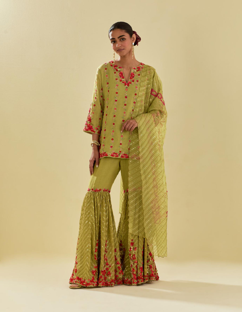 Green tissue chanderi short kurta set with round neck and slit in the front and all-over hand cut silk flower embroidery.