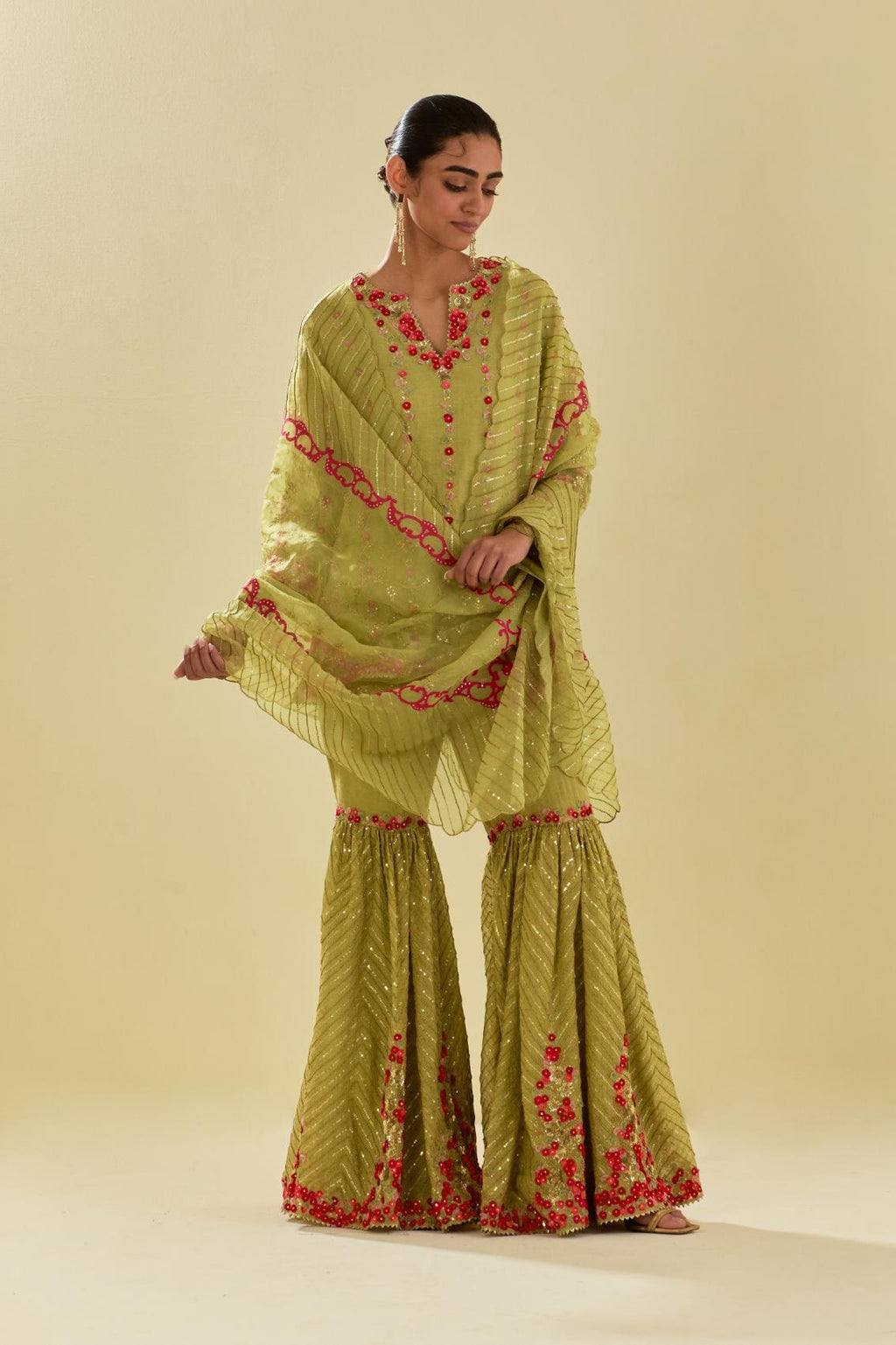Green tissue chanderi short kurta set with round neck and slit in the front and all-over hand cut silk flower embroidery.