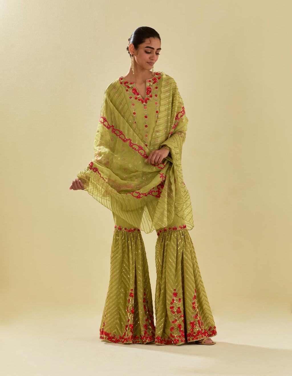 Green tissue chanderi short kurta set with round neck and slit in the front and all-over hand cut silk flower embroidery.