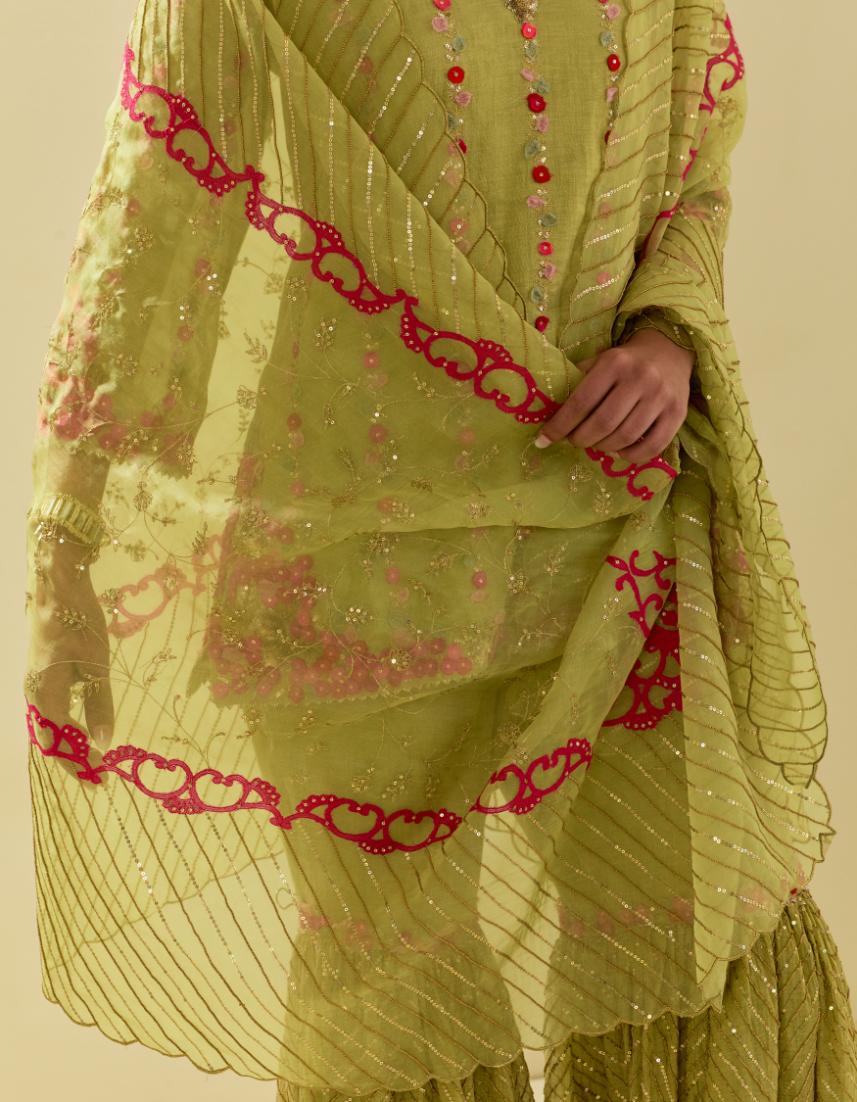Green tissue chanderi short kurta set with round neck and slit in the front and all-over hand cut silk flower embroidery.