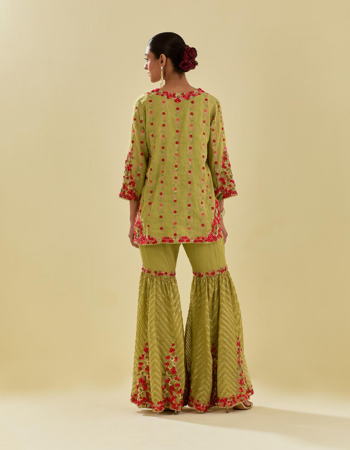 Green tissue chanderi short kurta set with round neck and slit in the front and all-over hand cut silk flower embroidery.