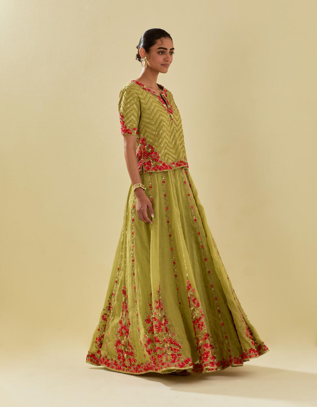 Green tissue chanderi short top set with delicate hand cut silk flower embroidery, highlighted with gold sequins and beads.