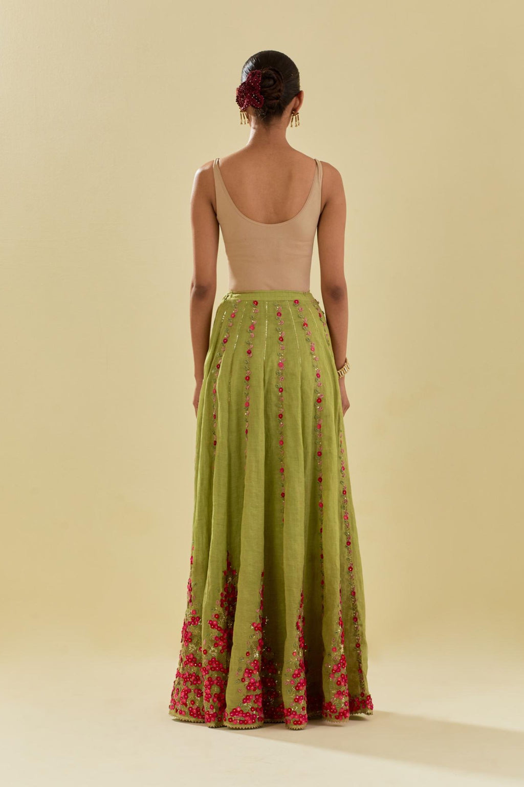 Green tissue chanderi lehenga with all-over delicate hand cut silk flower embroidery, highlighted with gold sequins.