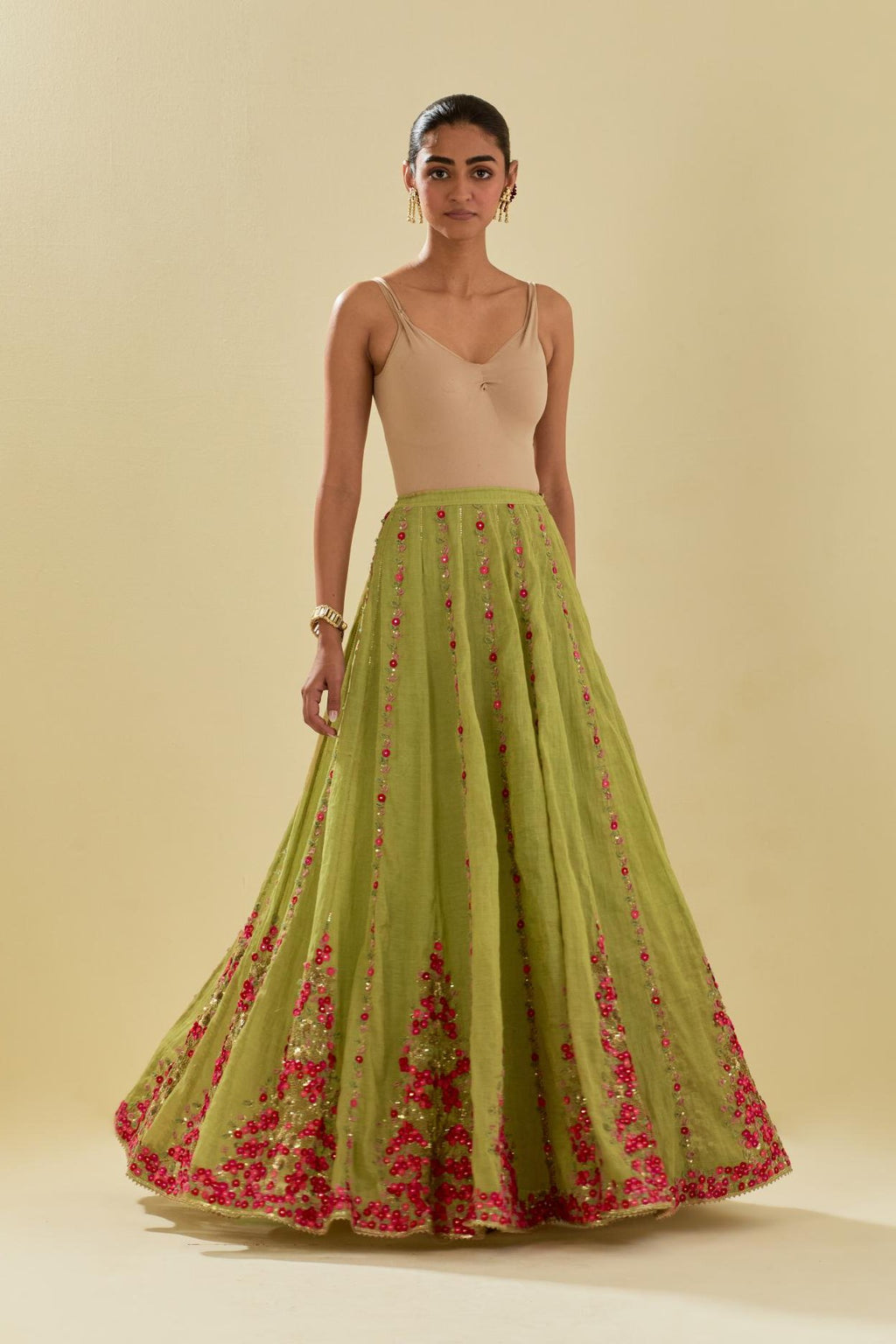 Green tissue chanderi lehenga with all-over delicate hand cut silk flower embroidery, highlighted with gold sequins.