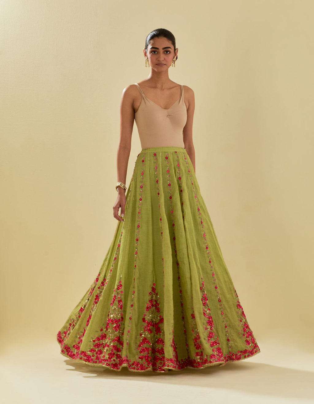 Green tissue chanderi lehenga with all-over delicate hand cut silk flower embroidery, highlighted with gold sequins.